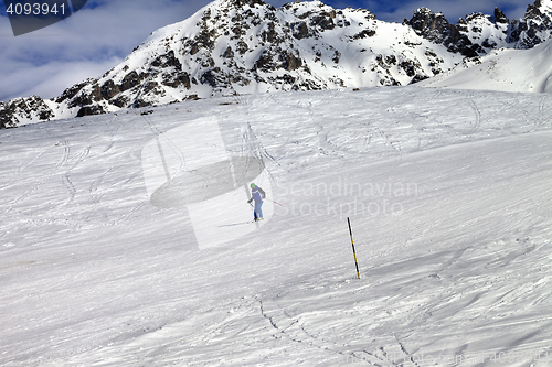 Image of Skier on ski slope at sun winter day
