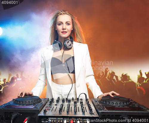 Image of Beautiful blonde DJ girl on decks - the party,