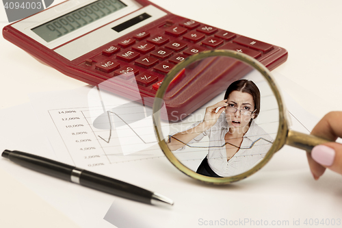 Image of Magnifying glass with chart on paper