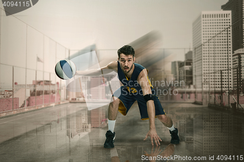 Image of Full length portrait of a basketball player with ball