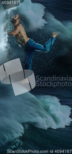 Image of The male break dancer in water.