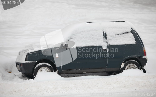 Image of  small car covered with snow
