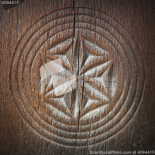 Image of carved symbol on ancient wood