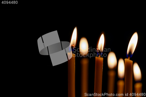 Image of bright candles in dark