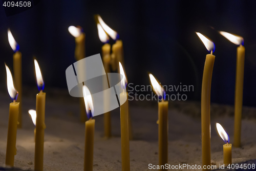 Image of bright candles in dark
