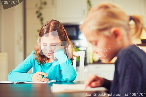 Image of Siblings are doing homework