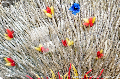 Image of Decoration of artificial flowers and ears of corn.