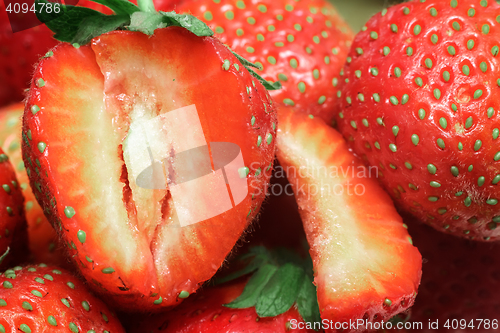 Image of Cut a ripe strawberry to the major plan.