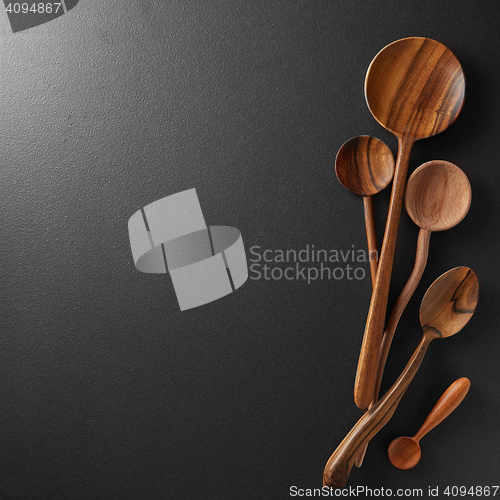 Image of Wood spoons on black board background