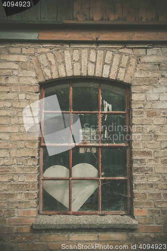 Image of Forgotten love heart in a window 