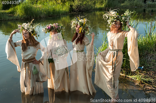 Image of Beautiful women with flower wreath in water