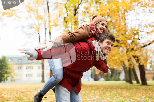 Image of happy young couple having fun in autumn park