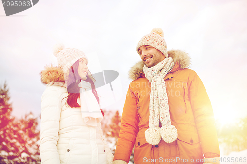 Image of happy couple walking over winter background