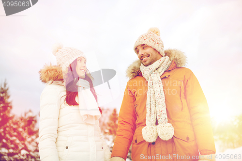 Image of happy couple walking over winter background