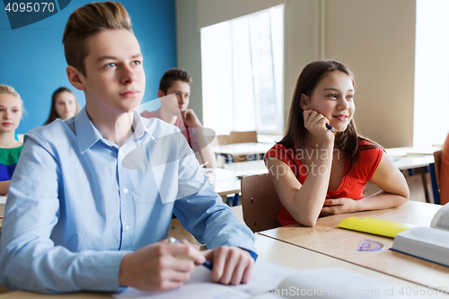 Image of group of students with notebooks at school lesson