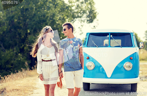 Image of smiling young hippie couple over minivan car