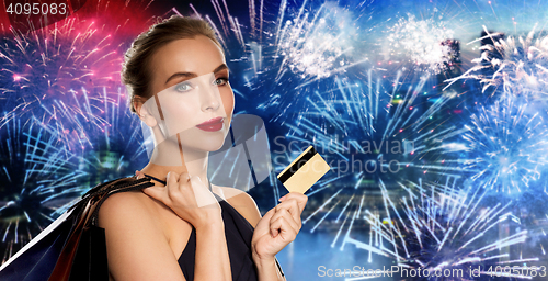 Image of woman with credit card and shopping bags