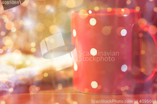 Image of red polka dot tea cup on wooden table