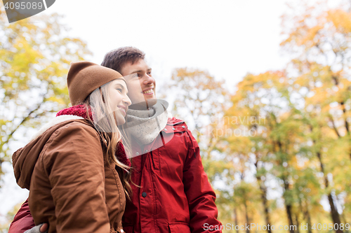 Image of happy young couple walking in autumn park