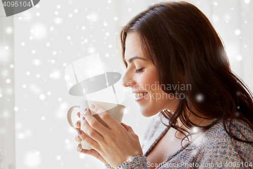 Image of happy woman with cup of tea or coffee at home