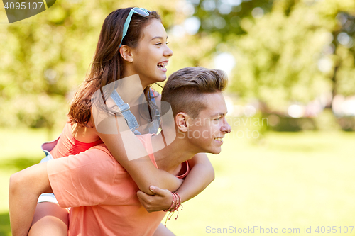 Image of happy teenage couple having fun at summer park