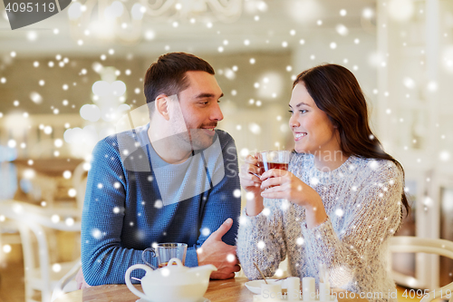 Image of happy couple drinking tea at cafe