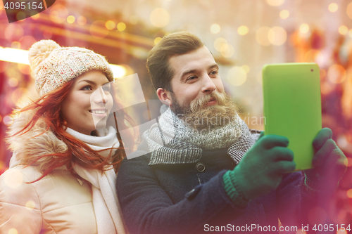 Image of couple taking selfie with tablet pc in old town