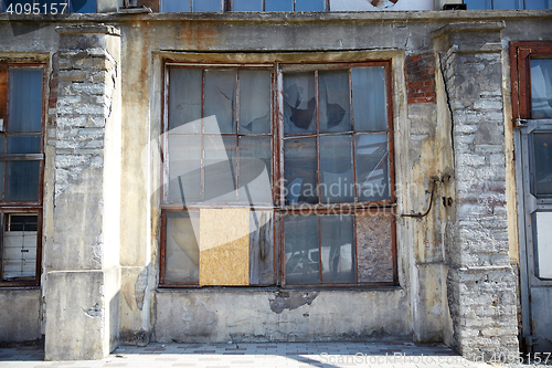 Image of old industrial building with broken glass window