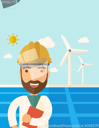 Image of Man in solar panel and windmills.