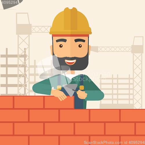 Image of Builder man is building a brick wall.