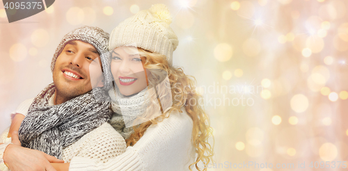 Image of happy family couple in winter clothes hugging