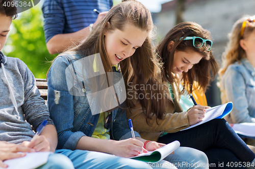 Image of group of students with notebooks at school yard