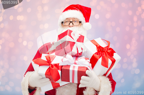 Image of man in costume of santa claus with gift boxes