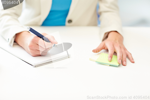 Image of close up of woman with to notepad at office