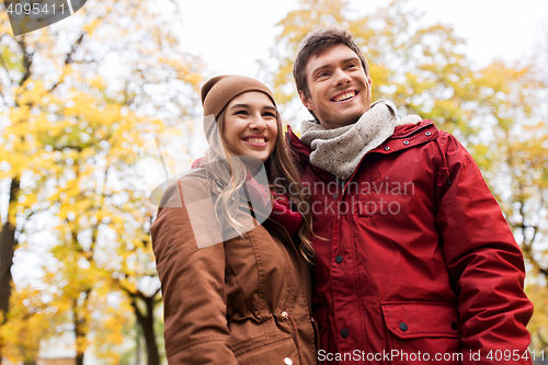 Image of happy young couple walking in autumn park