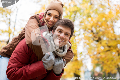 Image of happy young couple having fun in autumn park