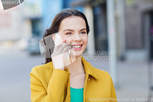 Image of smiling young woman or girl calling on smartphone