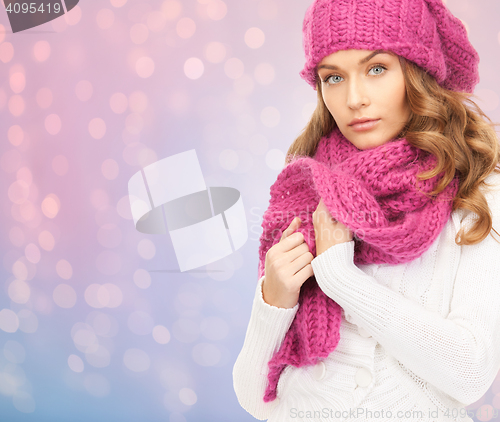 Image of close up of woman in hat and scarf over lights