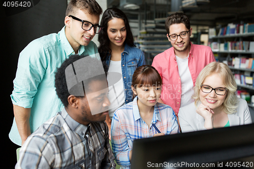 Image of international students with computers at library