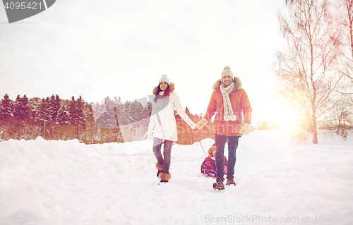Image of happy family with sled walking in winter outdoors