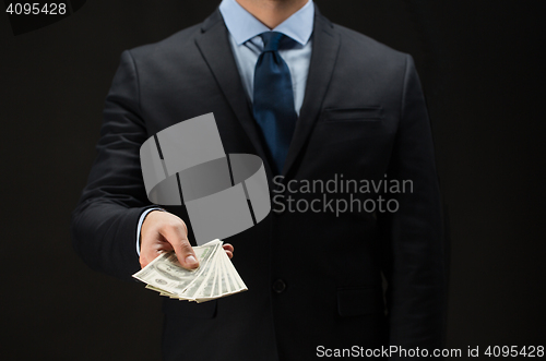 Image of close up of businessman hands holding money