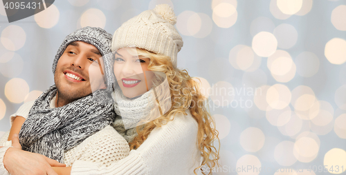 Image of happy family couple in winter clothes hugging