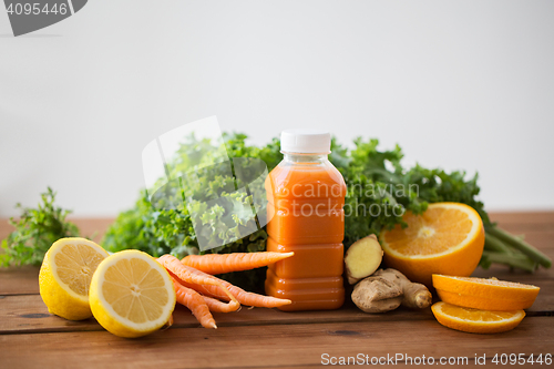 Image of bottle with carrot juice, fruits and vegetables