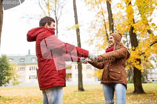 Image of happy young couple having fun in autumn park