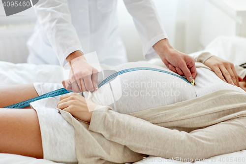 Image of close up of doctor and pregnant woman at hospital