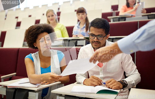Image of teacher giving tests to students at lecture