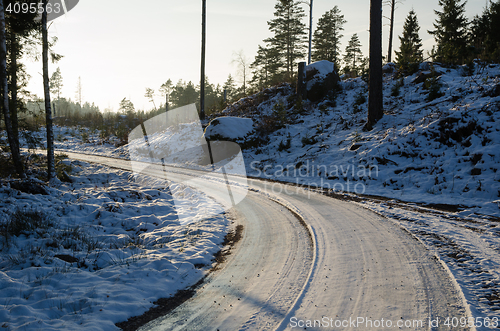 Image of Icy gravel road through a forest