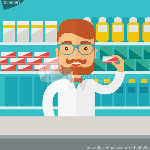 Image of Young  pharmacy chemist man standing in drugstore. 