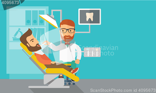 Image of Dentist man examines a patient\'s teeth in the clinic