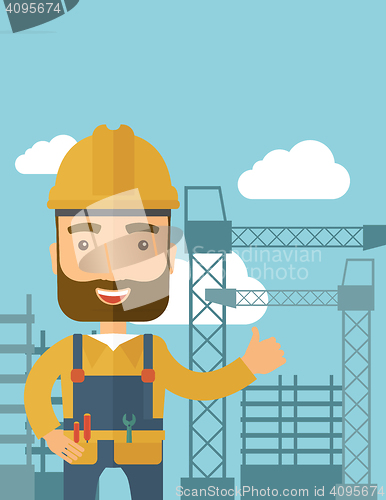 Image of Man standing infront of construction crane tower.